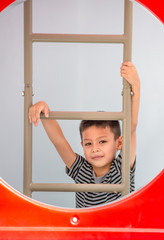 Portrait of Asian boys are climbing the ladder in the playground.