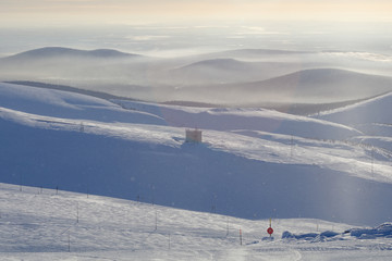 View from the top of the mountain to the top station of the ski lift