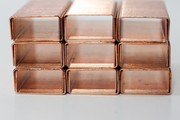 Metal staples of copper for stapler, in insulation with white background. Close up. Macro. selective focus