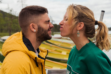 Finland, Lapland, funny young couple grimacing at the lakeside