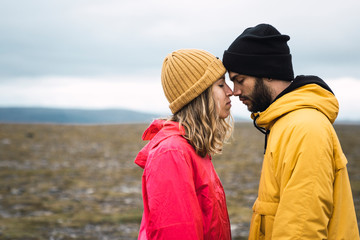Young couple rubbing affectionately noses, Lapland, Norway