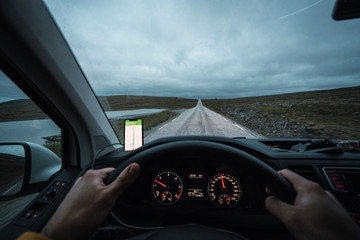 Young man driving car in Lapland, Norway
