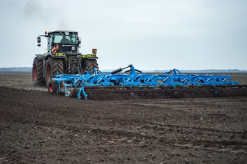 Fototapeta premium Seedbed cultivator and Land cultivation with tractor