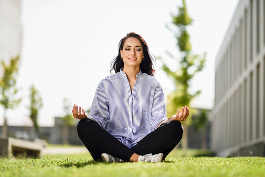 Portrait of student doing yoga exercises on campus