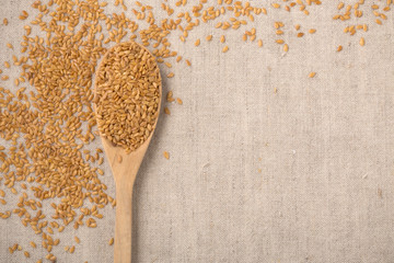 Golden flaxseed background, top view