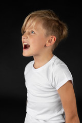 little blond boy is groaning and screaming