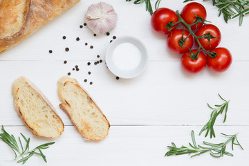 Bruschetta ingredients with mozzarella, cherry tomatoes and fresh garden rosemary. Top view with space for your text