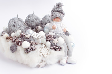 White fur Christmas wreath decoration for December with candles and happy elf figure and sled Holiday celebration, pine cone luxury postcard wallpaper and background