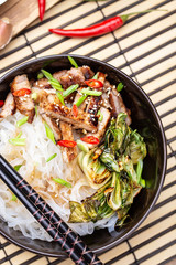 Spicy rice noodles wok with pork and bok choy