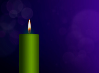 Green burning candle on blue background