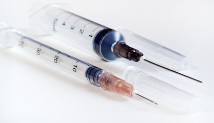 Disposable syringe. Plastic insulin syringe. The insulin syringe with the lid open shows sharp needles. Injection medicine. Medical equipment.