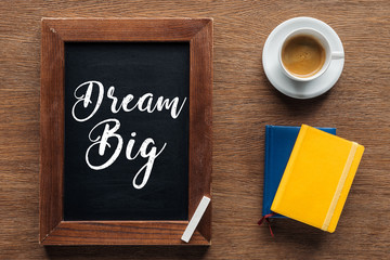 top view of chalk board with 'dream big' lettering on wooden background