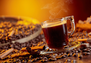 Espresso coffee cup with brown sugar and cinnamon sticks.
