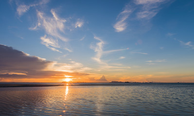 Fototapeta na wymiar Beautiful beach sunset with big rain clouds and golden light sky background