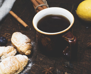 brown ceramic cup with black tea