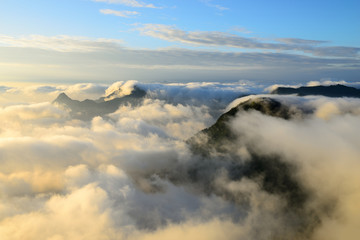 Natural landscape view with mists sea at sunrise. Mists in the cove. Mountain of fog, sun and win.