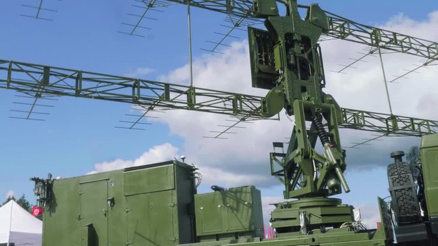 Spinning part of modernized mobile reconnaissance target resegnation radar with blue sky on background. Peaceful skies
