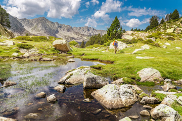 Impressive view of Pyrenees landscape in Andorra, with woman hiker