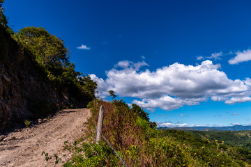 Fototapeta na wymiar barbwire fence on trail in Guatemalan mountains