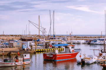 Fototapeta premium Many modern vessels floating on water in port of coastal city