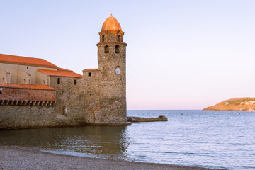 Wonderful ancient castle located on sea shore against clear blue sky
