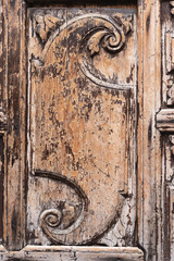 Closeup view of decorative element on old vintage wooden door. Vertical color photography.