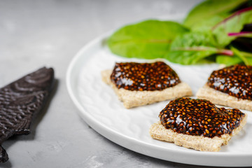 Vegan caviar made with chia seeds and nori. Appetizers on whole grain crispbreads