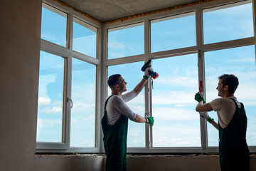 Men are installing a window