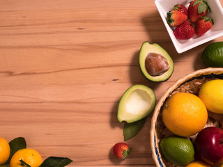 close up of fruits and berries lying on a wooden surface. Background