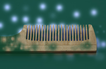 wooden comb on a green background