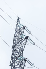 high-voltage tower on a grey sky of background