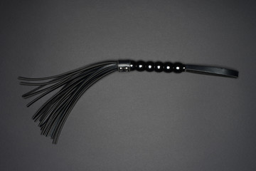leather handle black flogging whip isolated on grey