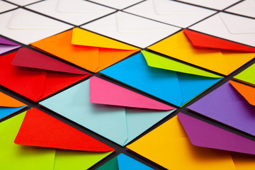 Composition with white and colored envelopes on the table.