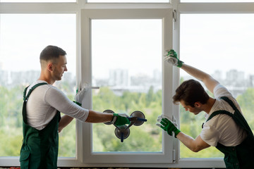 Men mounting a window section