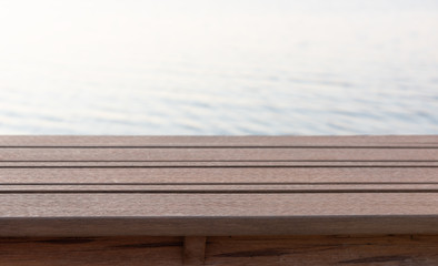 Plank wood table top  with blurred blue sea background