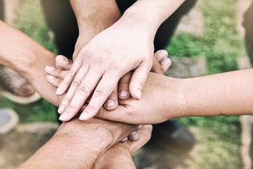 The abstract art design background of human hands touching together,teamwork concept,blurry light around