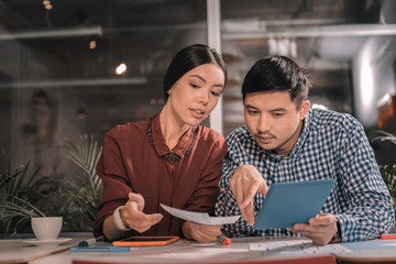Two economists feeling busy while doing accounting together