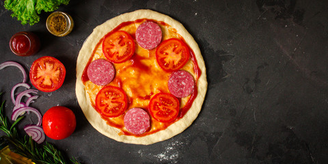 pizza, dough, ingredients, pepperoni, cheese, toatny sauce (cooking process). Top view with copy space