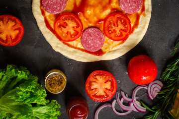 pizza, dough, ingredients, pepperoni, cheese, toatny sauce (cooking process). Top view with copy space
