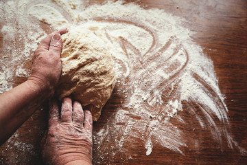 Yeast and baking lessons. Hands are preparing dough for baking.