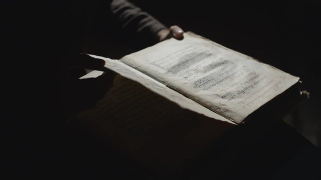 Someone is looking for something in the old book