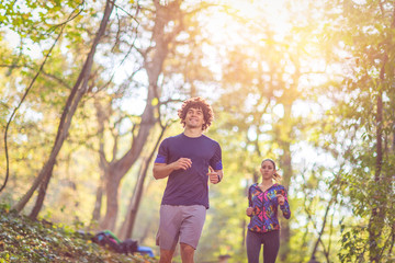 running is fun- Couple jogging and running outdoors in nature.