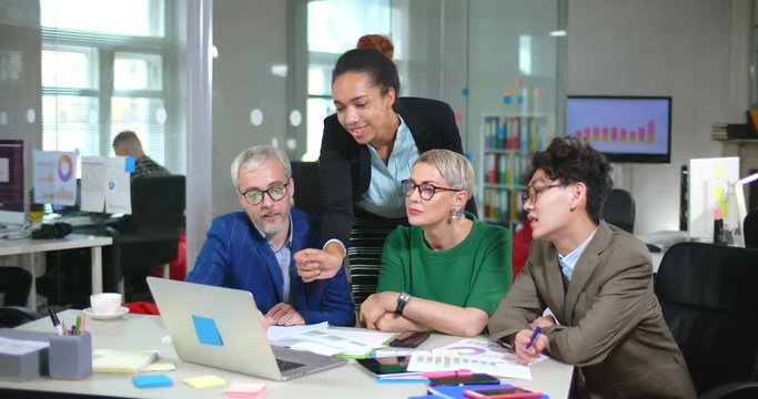 Multiethnic team coworking in marketing consulting company office.