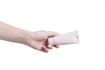 woman applying moisturizing hand cream. Pink tube in female's hands isolated on white background