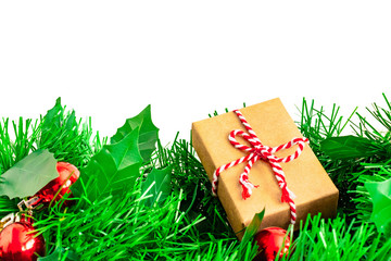 Christmas tree branches with balls and hand made gift of Kraft wrapping paper, isolated on white, copy space