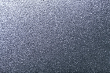Textural of silver background of wavy corrugated paper, closeup.