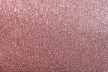 Textural of red background of wavy corrugated paper, closeup.