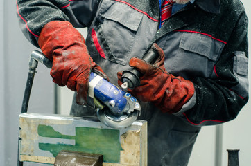 Worker using a grinder.