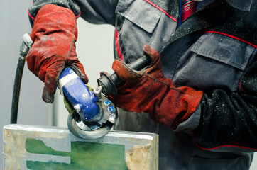 Worker using a grinder.