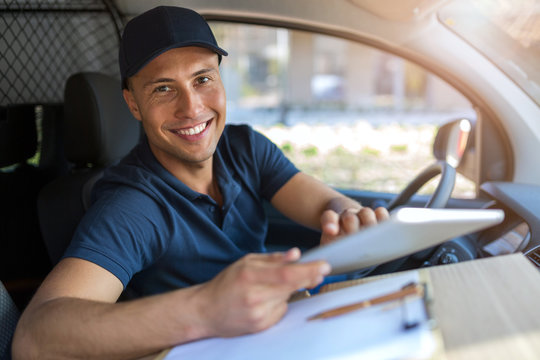 Delivery man sitting in a delivery van